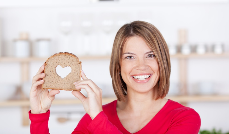 woman-holding-slice-of-bread