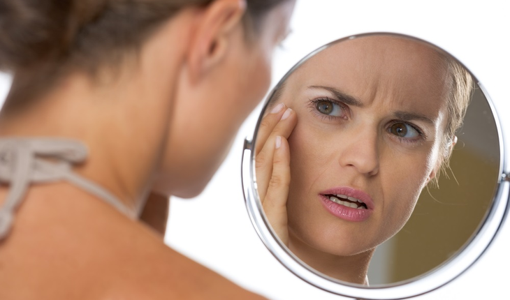 Woman looking in mirror