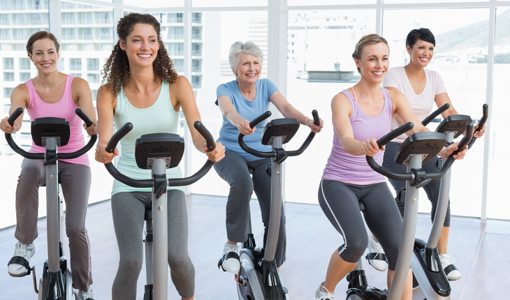 Women bicycling in gym