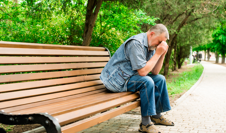 depressed older man on park bench