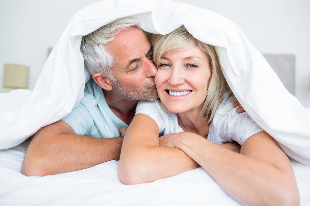 mature couple happy in bed