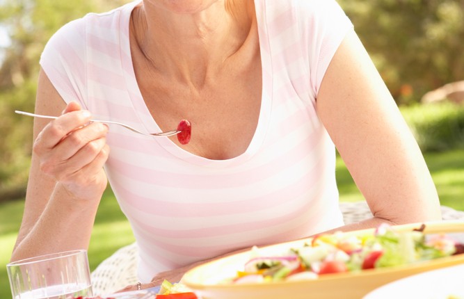 mature woman eating healthy food