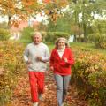 older cojuple running in autumn