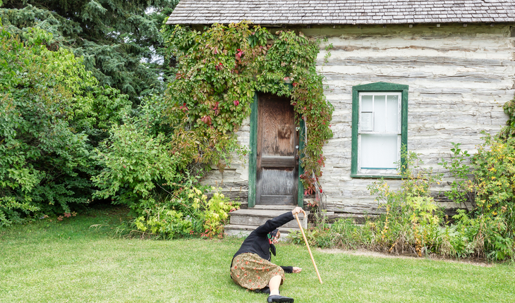 older woman falling down on grass