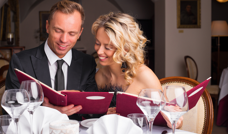 Woman leaning over to look at her dates menu