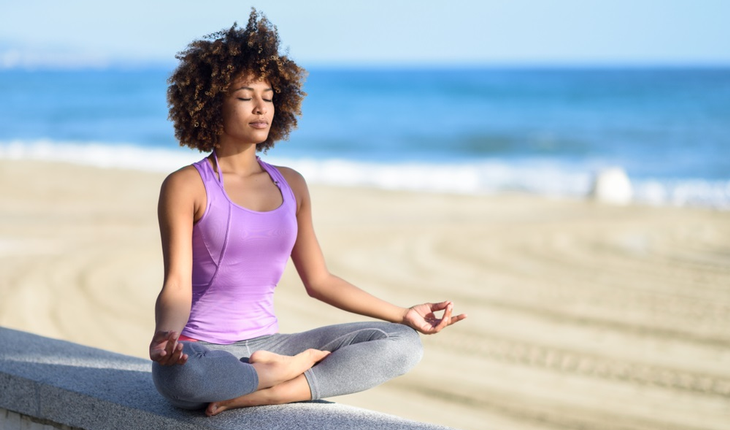 woman-meditating-on-beach
