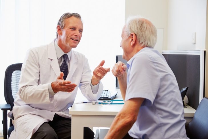 doctor talking with patient in office