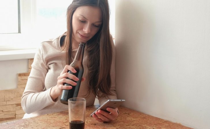 Student posting on social media while drunk