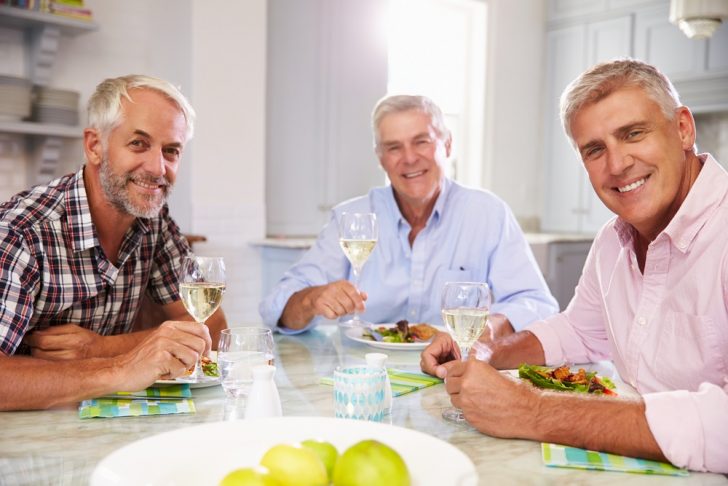 Three men having a meal together