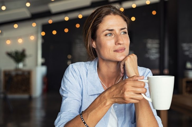 Woman in cafe with coffee cup