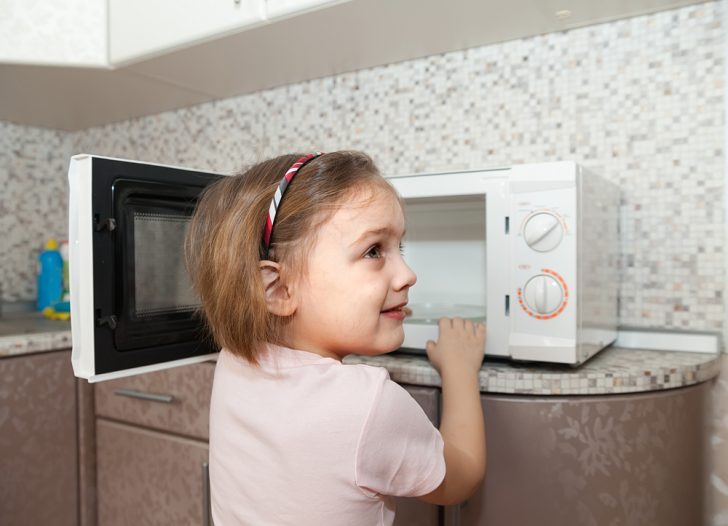 Child using microwave