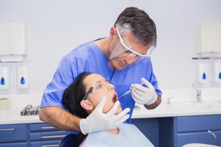 dentist wearing a face shield